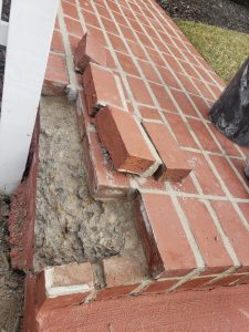 Brick And Stone Repairs 9 Brick repair because Several bricks are missing and dislodged from the edge of a brick step, exposing rough concrete underneath and creating a damaged, uneven surface.
